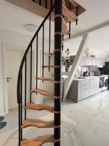 a spiral staircase in a house with a kitchen at Zimmer in Wattenbek in Wattenbek +26 photos