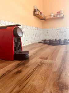 a red toaster sitting on top of a wooden floor at Cap Alizés in Petit-Canal +2 photos