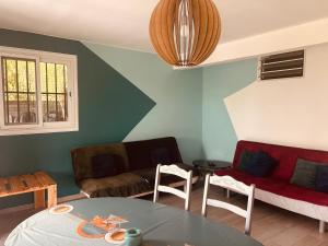 a living room with a couch and a table at Cap Alizés in Petit-Canal
