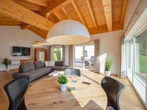 a living room with a table and a couch at Walser Lodge in Mittelberg