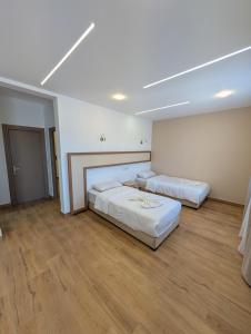 Zwei Betten in einem großen Zimmer mit Holzboden in der Unterkunft Side surfing in Aourir + 5 Fotos