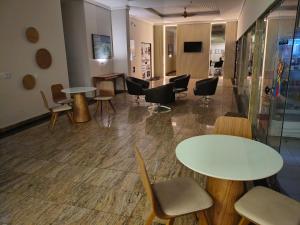 a waiting room with two tables and chairs at BOA VIAGEM FLATS APTO 201 in Recife