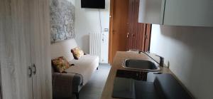 a kitchen with a couch and a sink in a room at The Garden House in Boiano