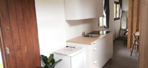 a white kitchen with a sink and a counter at The Garden House in Boiano +20 photos