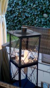 a bird cage with lights on a table at Chiantirooms Guesthouse in Greve in Chianti