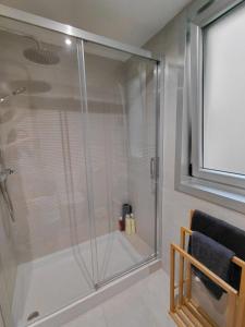 a shower with a glass door in a bathroom at Brisas de Malpica in Malpica +7 photos