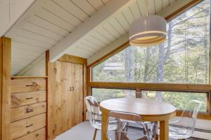 a dining room with a table and chairs and a window at Resort-Style Community! Quechee Chalet w/ Deck in Quechee