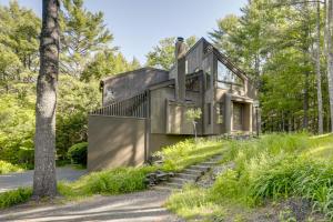 a house in the woods with stairs leading up to it at Resort-Style Community! Quechee Chalet w/ Deck in Quechee