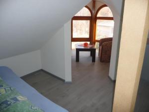 a room with a table and a window at Apartments Excalibur Despotovac - Kod upravnika in Despotovac