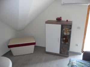 a room with a stool and a shelf with teddy bears at Apartments Excalibur Despotovac - Kod upravnika in Despotovac