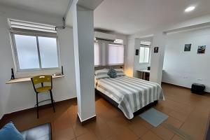 a bedroom with a bed and a chair in it at Our Home San Antonio in Cali
