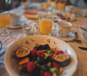 a plate of fruit and vegetables on a table at B&B Pronkenburg in Lissewege +29 photos