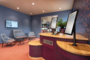 a waiting room with two chairs and a reception desk at b-smart hotel Arbon in Arbon
