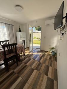 a living room with a dining table and a kitchen at Colibrí in Merlo