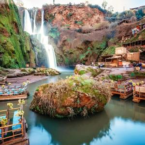 a waterfall in the middle of a body of water at DAIFLAH Guesthouse & Hostel in Oulad Rguia