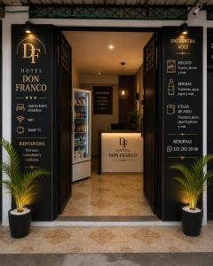 a store entrance with potted plants in front of it at Hotel Don Franco in Villagarzón