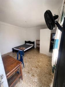 a room with a bed and a table in a room at Hotel Don Franco in Villagarzón +4 photos