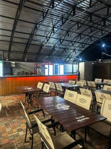 a restaurant with wooden tables and chairs and a kitchen at Green Village in Balqash