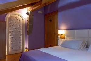 a bedroom with a white bed and purple walls at Villa Di Natale in Pagani