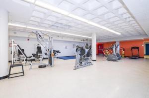 a gym with several treadmills and machines in a room at Résidences du Cégep de Rimouski in Rimouski