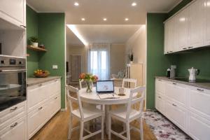a kitchen with a table with a laptop on it at Guest House 36 private parking in Orbetello