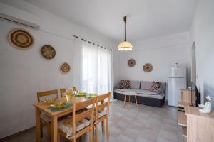 a kitchen and living room with a table and a couch at Corfu Glyfada Beach Apartments in Glyfada