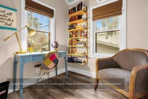 a desk and a chair in a room with a window at Mills Cottage in Orlando