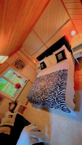 a bedroom with a zebra print bed in a attic at BAPA STAYs COZY CABIN A by the Ivö lake in Kristianstad