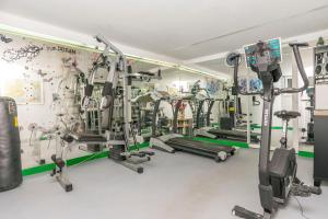 a gym with treadmills and machines in a room at Apartments Adriatic Relax, heated pool, parking place in Duće