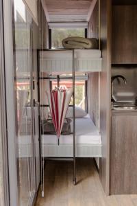 a room with three bunk beds with an umbrella at Aslan Haus in Villarrica