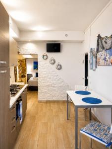 a kitchen and living room with a table and chairs at Carbonari Holiday House in Cefalù +7 photos