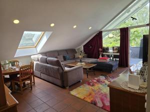 a living room with a couch and a table at 'Tor zum Schwarzwald' Ferienwohnungen mit Sauna in Wildberg