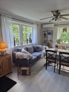 a living room with a couch and a table at Utleiebolig Fannrem in Fannrem +14 photos