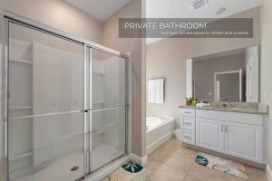 a bathroom with a shower and a sink and a tub at Spacious 5BR 45BA Home w Pool in Davenport