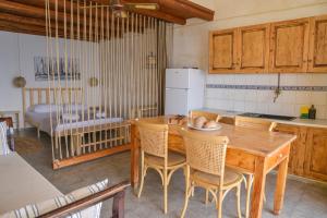 a kitchen with a wooden table and chairs at Rota in Klima
