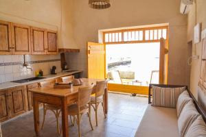 a kitchen with a table and chairs and a couch at Rota in Klima