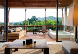 a living room with a view of a tub at Veranda High Resort Chiang Mai - MGallery Collection, Accor Hotel in Hang Dong