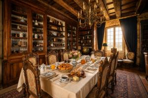 a dining room with a table with food on it at Château de Chalus-Chabrol in Châlus