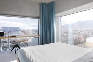 a bedroom with a bed and a large window at Placid Hotel Design & Lifestyle Zurich in Zürich