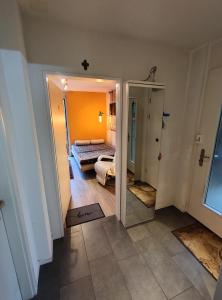 a room with a bedroom with a bed and a mirror at Zimmer oberhalb Kreuzlingen in Kreuzlingen
