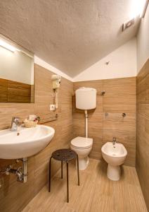 a bathroom with a sink and a toilet at Hotel Letizia in Bellaria-Igea Marina +127 photos