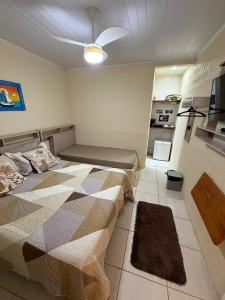 a bedroom with a bed and a ceiling fan at Pousada Recanto da Ana Alice in Abraão