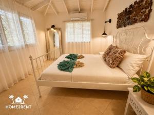 a bedroom with a white bed in a room at Villa 300m from beach with shared swimming pool in Las Terrenas