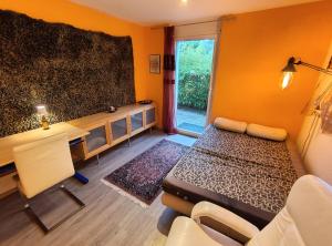 a room with a table and a desk with a window at Zimmer oberhalb Kreuzlingen in Kreuzlingen