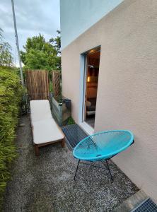 a blue bench and a chair next to a building at Zimmer oberhalb Kreuzlingen in Kreuzlingen