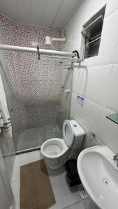 a bathroom with a shower and a toilet and a sink at Pousada Recanto da Ana Alice in Abraão +30 photos