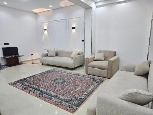 a living room with two couches and a rug at فيلا في كينج مريوط in Alexandria
