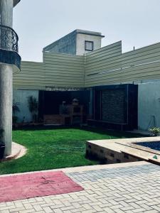 a large building with a grass yard in front of it at فيلا في كينج مريوط in Alexandria