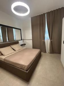 a bedroom with a large bed and a large window at Chloè Vacanze in Iesi
