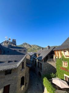 a group of buildings with mountains in the background at Casa Isabel, wifi y relax - Arafita Apartamentos in Sallent de Gállego